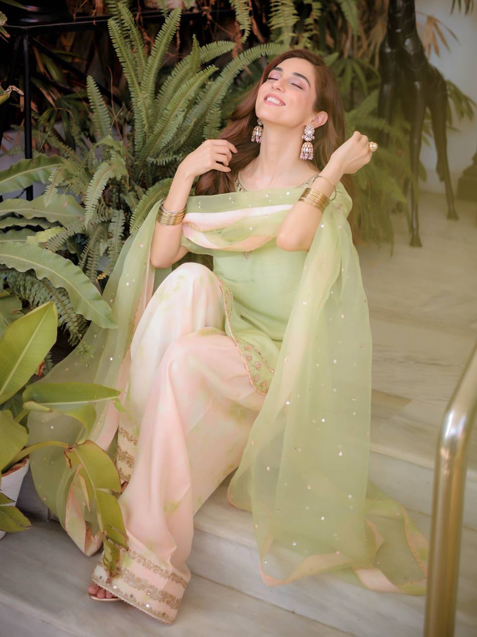 Serene Beauty: A Young Muse Adorned in Lush Green